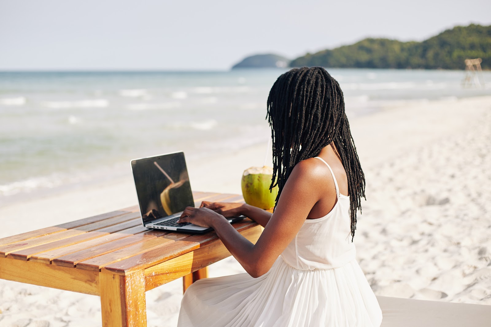 A remote employee working from the beach
